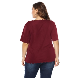Back view of plus-size wine red top with scalloped edges and short sleeves