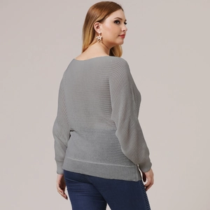 Detail view of grey oversized knit top featuring drop shoulders and mesh texture