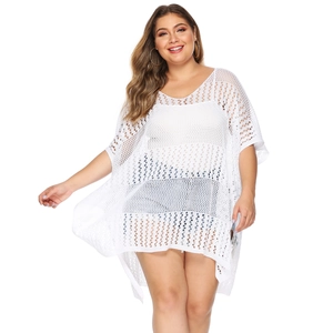 Close-up of white crochet beach cover-up featuring hollow mesh texture and V-neckline