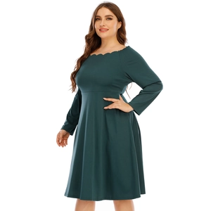 Dettaglio dell'elegante scollatura a festone e delle maniche lunghe dell'abito verde