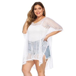 Detail of white crochet knit beach cover-up with hollow-out pattern and irregular hemline