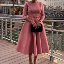 Detail of pink midi dress featuring pleated shawl sleeves and a matching wide waist belt