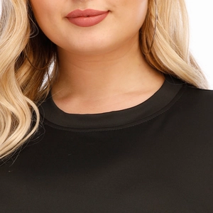 Close-up of black round neck top with smooth fabric and matching fine edge binding
