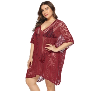 Detailed macro view of dark red crochet hollow out texture on this plus size beach cover up