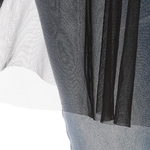 Detail of black mesh overlay on light blue denim fabric showing textile texture