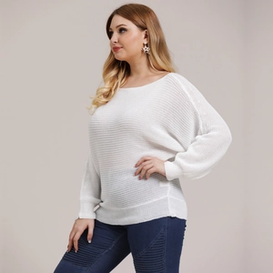 Detail view of white loose-knit long sleeve sweater showing fabric texture and drop shoulders