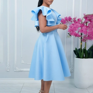 Detail of elegant light blue A-line dress featuring ruffle sleeves and structured fabric