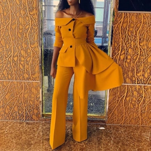 Detail of mustard yellow set showing ruffled off-shoulder top and wide-leg trousers
