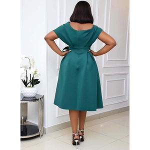 Detail of elegant dark green evening dress featuring a high waist and large bow on the back