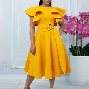 Detail of elegant yellow dress featuring ruffled sleeves and a buckled waist belt