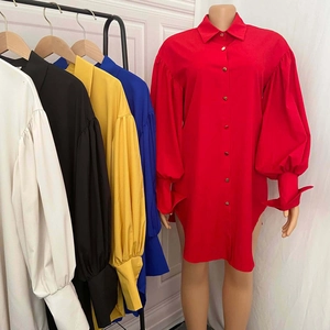 Detailed view of puff sleeves with long split cuffs on a solid button-down shirt dress