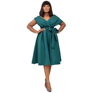 Detail of dark green V-neck dress with shoulder cutouts and elegant waist bow tie