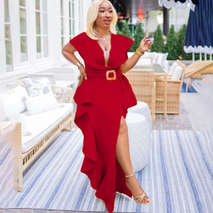 Detail of V-neck dark red maxi dress with gold buckle belt and ruffled slit hemline
