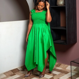 Elegant bright green smocked high-low dress with ruffles and a stylish bow strap