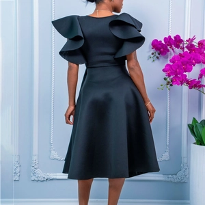 Detail view of the multi-layered ruffle sleeves on this elegant black dress back