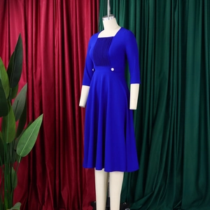 Detail of royal blue square neck dress showing fine vertical pleated texture and white buttons