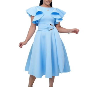 Detail of light blue elegant dress featuring layered ruffle sleeves and golden waist buckle