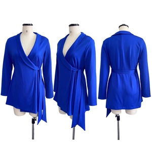 Detail of royal blue wrap dress showing V-neckline, waist tie and asymmetric hem