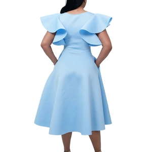 Detail view of light blue dress showing elegant ruffle sleeves and waist tie from the back