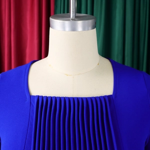 Detail of square neckline and vertical pleated bodice on a navy blue dress