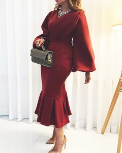 Detail of burgundy V-neck dress with puff sleeves and mermaid hem for formal events