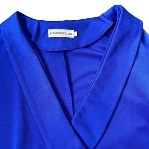 Detail of royal blue dress with V-neckline, ribbed fabric texture and sewn-in size label