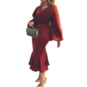 Detail of elegant deep red V-neck maxi dress with puff sleeves and ruffled mermaid hem