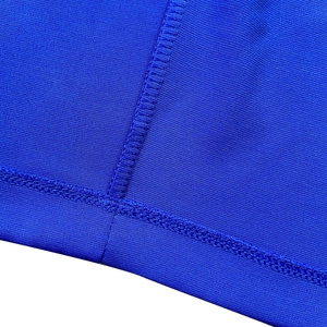 Macro detail of high-quality flatlock stitching on dark blue breathable mesh fabric