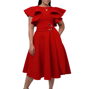 Detail of red elegant dress featuring ruffle sleeves and waist belt with gold buckle