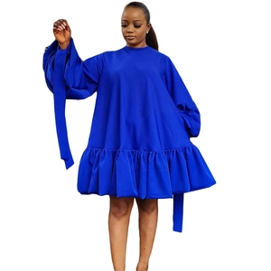 Close-up of royal blue tiered dress featuring puff sleeves and cuff ribbon ties