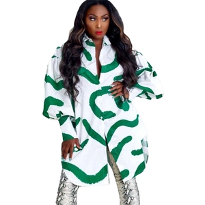 Close-up detail of white and green abstract stripe print shirt dress with puff sleeves