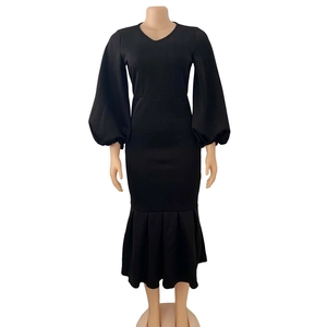 Detail of V-neckline and lantern sleeves on a black bodycon mermaid midi dress