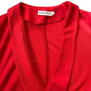 Close-up detail of the red knitted dress neckline with brand label and size S tag