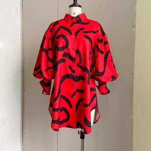 Detail of red floral print maxi shirt dress featuring lantern sleeves and lapel collar