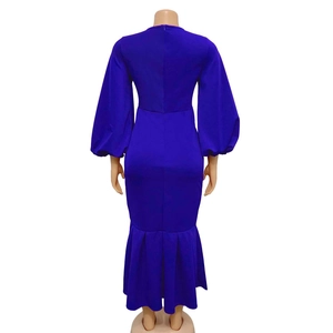 Detail view of the back zipper and mermaid hem on a navy blue long-sleeve dress
