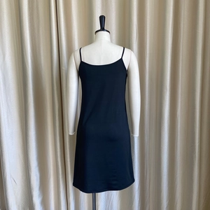 Detail of black camisole dress with spaghetti straps made from high-elasticity fabric