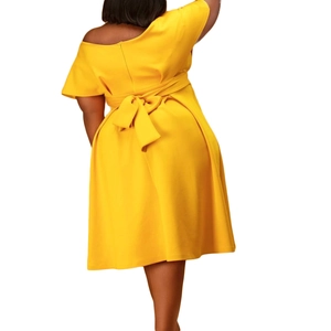 Back view of yellow V-neck dress with large waist bow and invisible zipper detail
