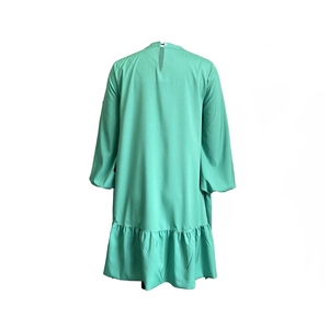 Detail of mint green puff sleeve dress with high collar and rear keyhole opening