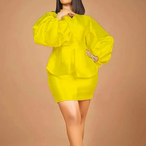 Close-up of vibrant yellow puff sleeves and peplum waist detail on an elegant skirt set