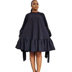 Women's loose black bubble sleeve dress with minimalist silhouette and ruffled hem