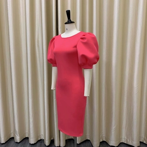 Vue latérale détaillée d'une robe midi rose vif avec manches bouffantes volumineuses et coupe ajustée