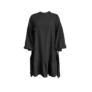 Detail view of the black long sleeve dress with puff sleeves and ruffled hemline
