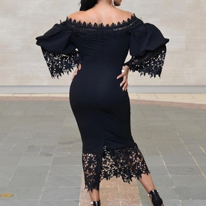 Close-up of elegant lace detailing on the back and hem of a black off-shoulder dress