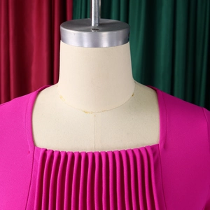 Close-up of square neckline and vertical pleated details on rose red dress bodice