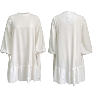 Detail view of white satin dress featuring elegant puff sleeves and tiered ruffle hemline