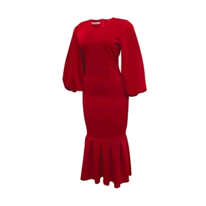 Detail of red long sleeve dress featuring dramatic lantern sleeves and a fishtail hemline