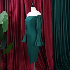 Detail of elegant off-shoulder dark green dress with flared sleeves and slim fit