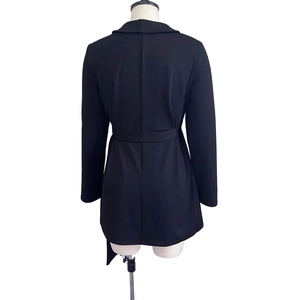 Back view of a slim-fit black long-sleeve blazer dress with an adjustable waist belt