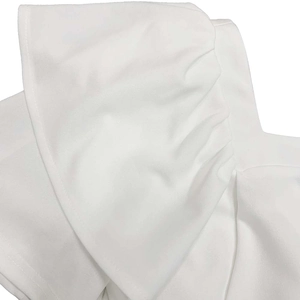 Close-up detail of white ruffled layers and pleated texture on an elegant dress