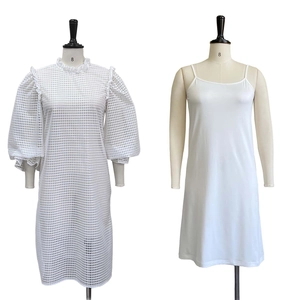 Detailed view of white two-piece dress with hollow mesh lace and puff sleeves on mannequins